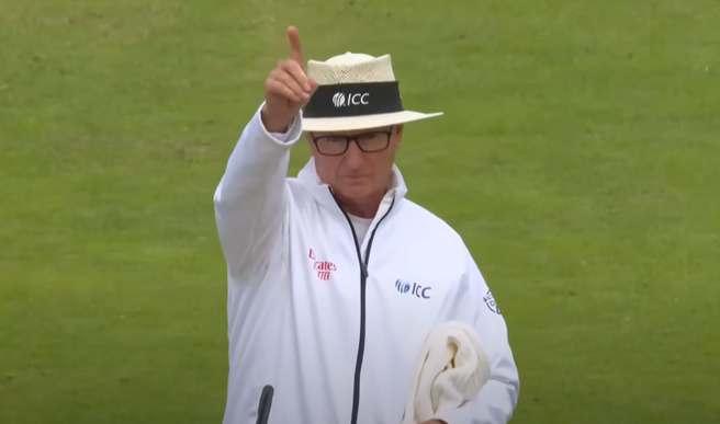 A cricket umpire signaling a decision on the fiel